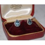 A pair of white metal aquamarine and diamond stud earrings, stamped '375'