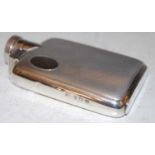 A vintage Birmingham silver hip flask of small size with hinged screw cover, engine turned details