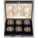 A cased set of six Middle Eastern white metal combination salts / napkin rings with pierced