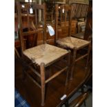 A pair of early 20th century Arts & Crafts stained beech childs side chairs with woven rush seats