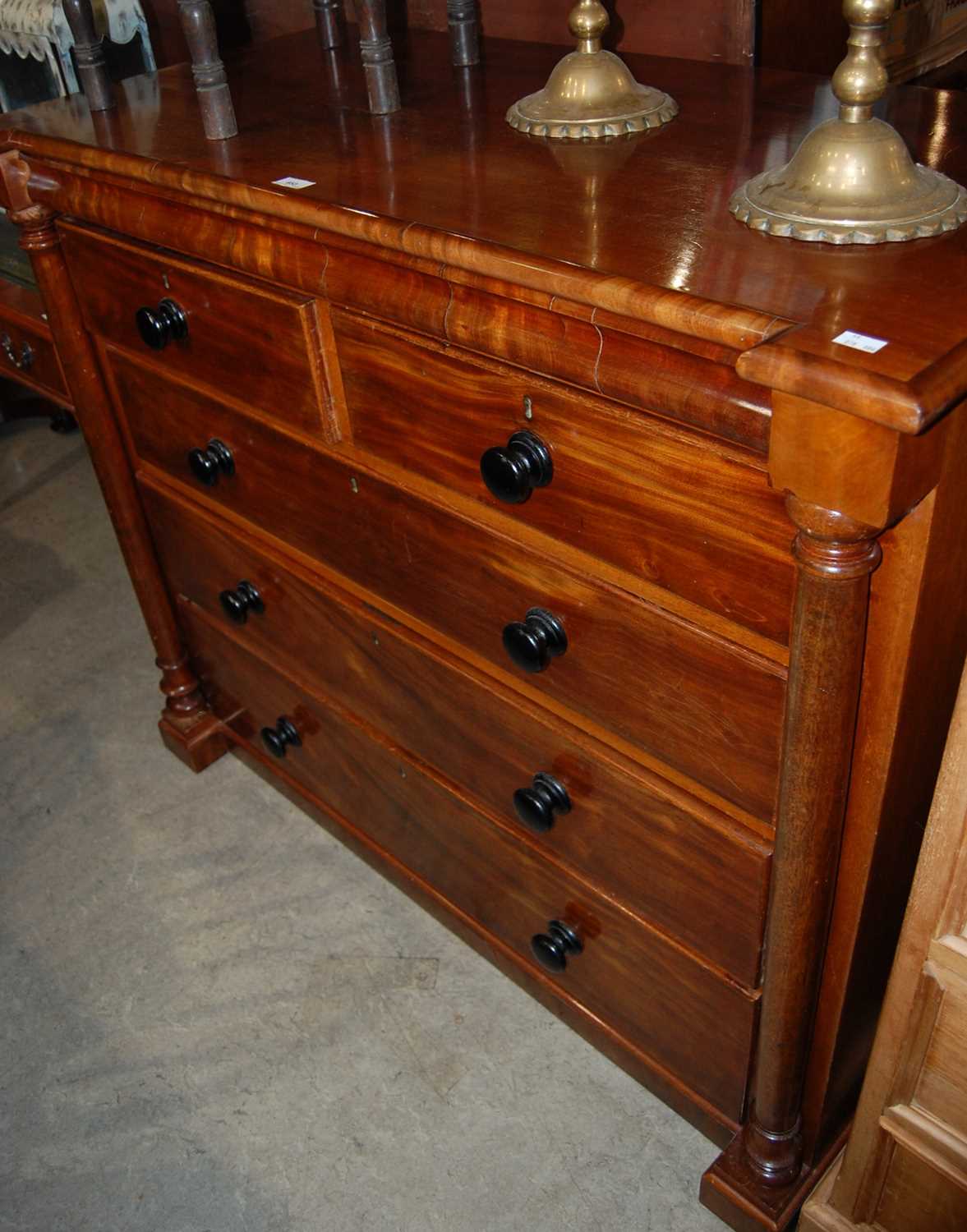 A 19th century mahogany chest of two short over three long graduated drawers with ebonised, turned