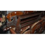 A mahogany carved plate rack flanked by griffins, together with another mahogany carved hanging