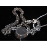 A late 19th / early 20th century white metal Albert chain suspending a Birmingham silver pendant/