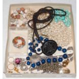A box of assorted costume jewellery to include a Victorian jet type oval brooch carved in relief
