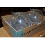 A pair of vintage clear glass spheres with etched detail and metal loop hanging fixtures,