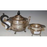 A Birmingham silver teapot raised on four shell and claw supports, together with a Birmingham silver