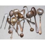 A collection of assorted silver and white metal flatware, to include various spoons, sugar tongs,