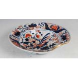A Japanese Imari porcelain barbers bowl, 19th century, decorated with an urn issuing flowers and