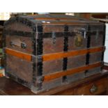 A vintage wood and metal bound Saratoga dome top trunk