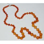 A vintage butterscotch amber and clear amber bead necklace, gross weight 10.8grams