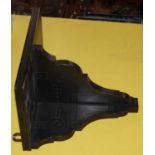 A Victorian ebonised carved wall bracket with gilded details, 30cm wide