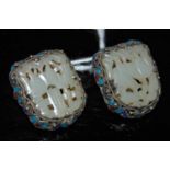 A pair of Chinese pale celadon jade and white metal mounted clip earrings with blue and purple