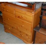 A modern pine chest of two short over two long drawers and pine side table with two frieze drawers