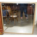 A gilt framed rectangular bevelled wall mirror, 113cm high x 112cm wide