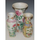 Three Chinese porcelain vases to include a famille rose sleeve vase, bearing Kangxi six character