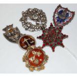 A group of six assorted brooches to include a white metal and paste set pendant brooch, white