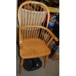 A modern blonde wood spindle-back Windsor armchair