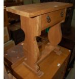 A 20th century oak rectangular side table with single frieze drawer bearing handles from a 19th