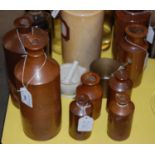 A collection of stoneware jars / ink bottles, together with a brass mortar and pestle, and another