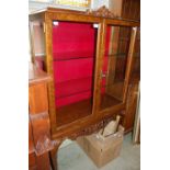 A 20th century walnut display cabinet raised on four cabriole supports