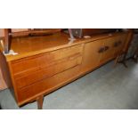 A stylish mid 20th century teak sideboard, set with a bank of three drawers, two cupboard doors