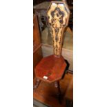 A stained wood spinning chair with inlaid upright back support