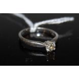 A platinum and diamond solitaire ring, set with a single round brilliant cut diamond, estimated to