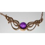 A 9ct gold Arts and Crafts style necklace centred with a purple cabochon stone, gross weight 11.4