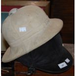 A vintage pith helmet, together with a Loveson riding helmet