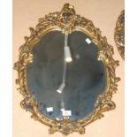 A composite gilt framed Rococo style oval wall mirror, 66cm high x 49cm wide