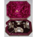 A cased set of four Victorian silver Neoclassical style canoe-shaped salts and spoons