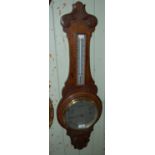 A carved oak mercury filled barometer