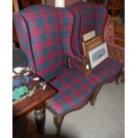 A pair of tartan upholstered wing back armchairs with brass studded detail