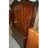 A 19th century mahogany linen press, the upper section with two cupboard doors opening to a full
