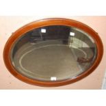 An Edwardian oval bevelled wall mirror with chequered strung detail, 53cm x 68cm