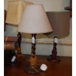 A near pair of wooden table lamps with barley twist columns, together with another mahogany table