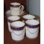 A Royal Crown Derby part coffee set, decorated with cobalt blue ground borders and gilded floral