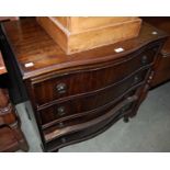A reproduction mahogany four drawer serpentine chest