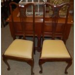 A set of four early 20th century darkwood dining chairs with ochre upholstered drop-in seats