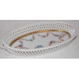 A Herend hand-painted porcelain oval basket with lattice-work border, signed 'Andraine', 26cm wide