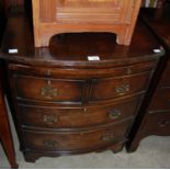 An early 20th century reproduction mahogany bachelors bowfront chest with pull-out brush slide,