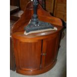 A late 19th century low mahogany corner cupboard with two panelled doors and upright gallery back