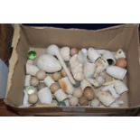 A box containing various parts of clay pipes, stoneware balls etc