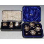 A Chester silver Art Deco style octagonal-shaped three-piece cruet set, together with a cased set of