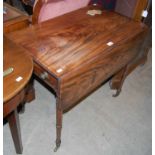 A Regency mahogany and ebony lined drop-leaf pembroke table with single end drawer on tapered ring