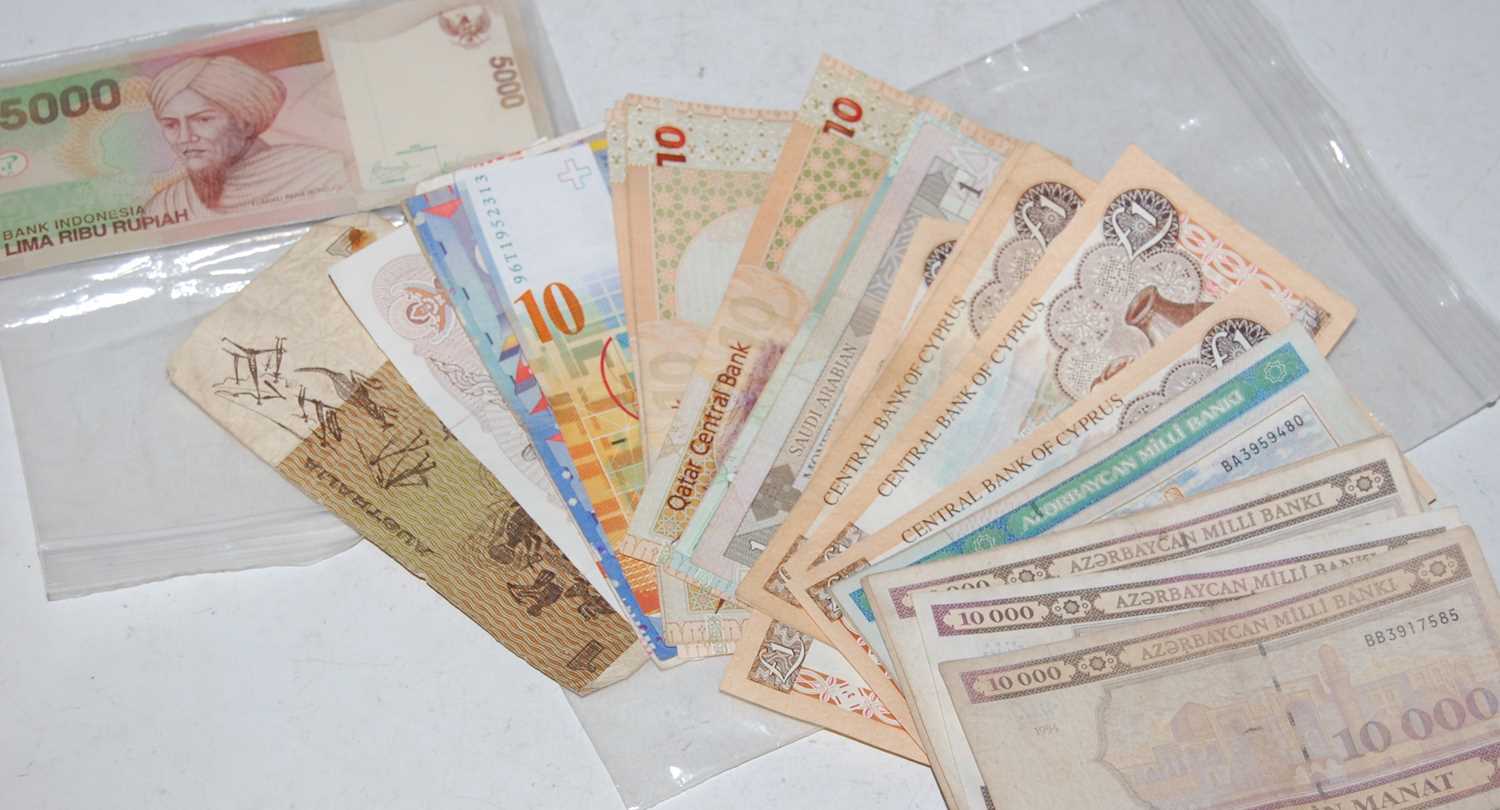A collection of assorted banknotes of the world to include Bank of Indonesia, Central Bank of
