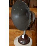 A vintage gramophone horn mounted on a circular base