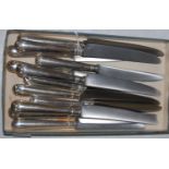 Six silver handled table knives and six matching silver handled dessert knives