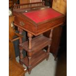 A mahogany lectern with red leatherette insert on a rectangular frame with two under tiers, the
