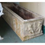 A composite stone rectangular garden planter decorated in relief with cherubs, 117cm long x 35cm
